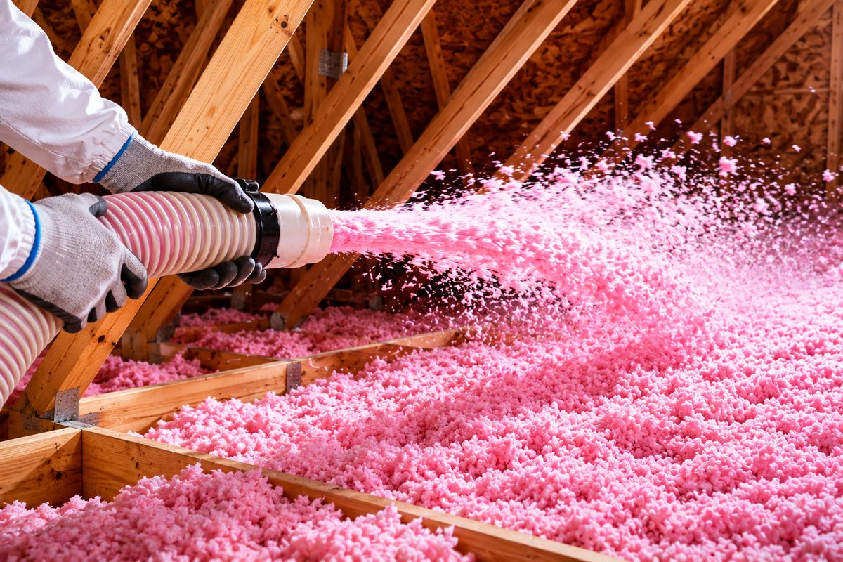Blowing Owens Corning insulation across the attic to full depth